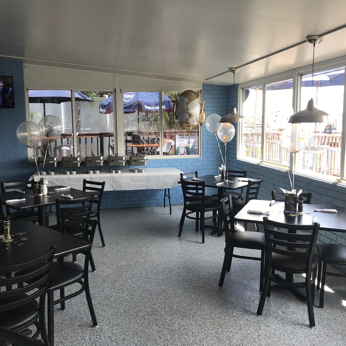 Whiskey River dining room set up with tables and a buffet for a gathering