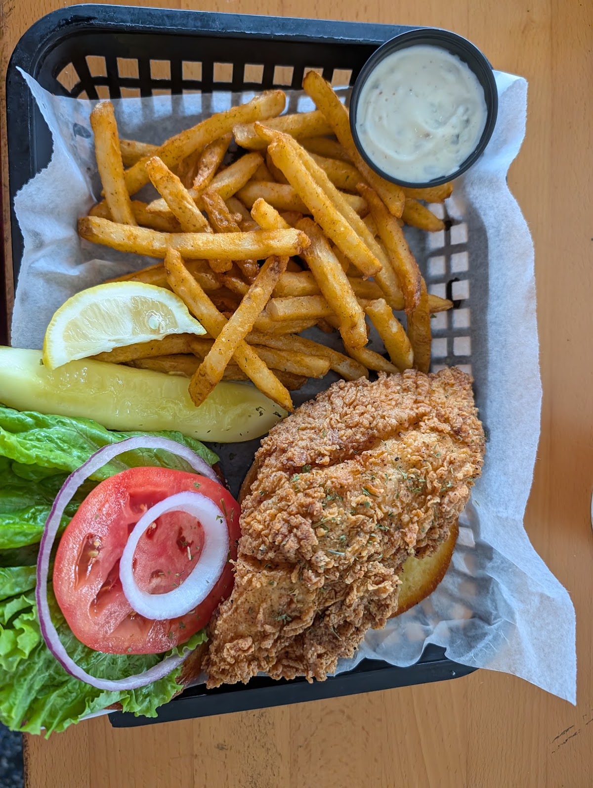 A fish sandwich with fries served at Whiskey River