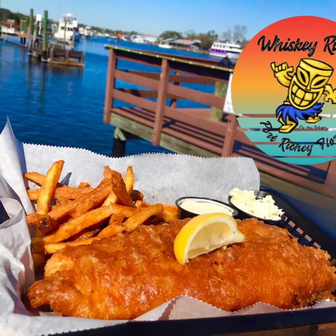 Fish and chips photographed beside the water by Whiskey River